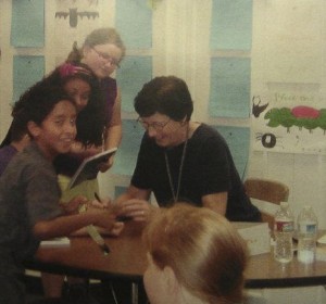Gale signing books at a school